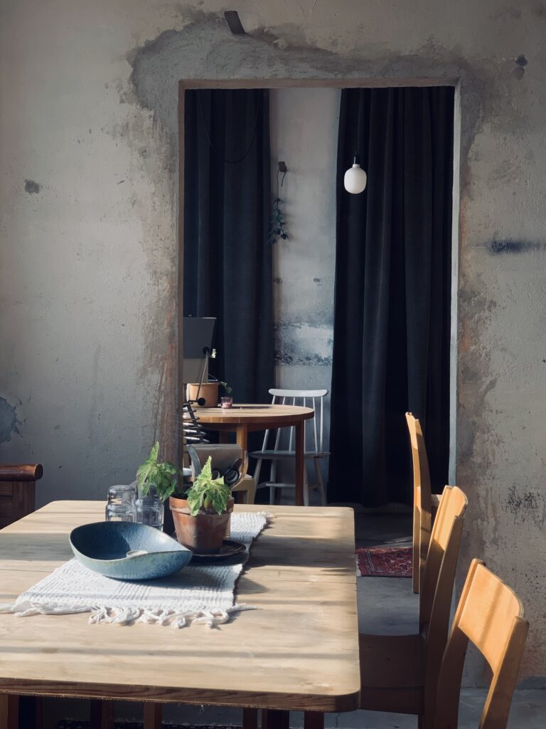 Table and chairs in front of door frame. evening sun.